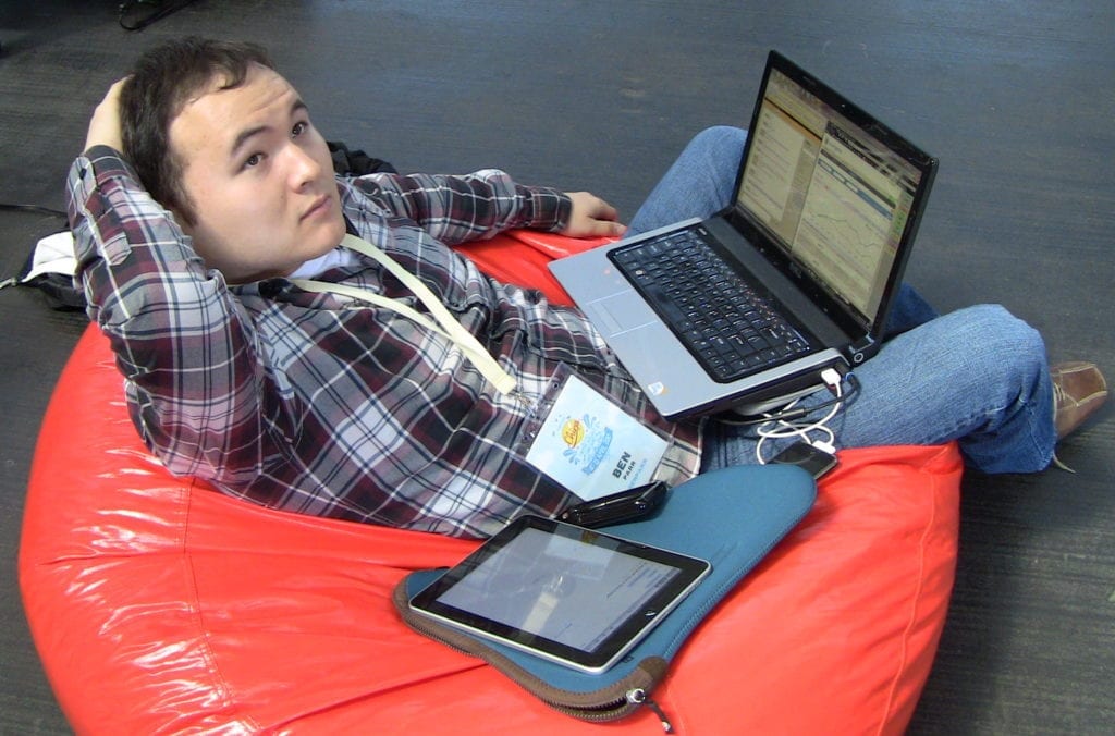 Ben Parr, at Chirp conference, sits in bean bag chair with laptop on lap.