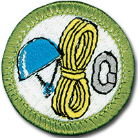 Rock climbing merit badge for Boy Scouts, featuring rope, helmet and carabiner 